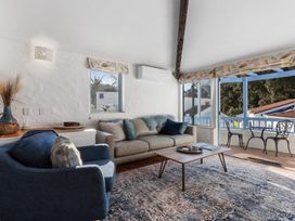 A living room with a sofa and coffee table at Sea Breeze - Orewa Oceanside Apartments in Orewa