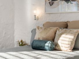 A bedroom with a bed and decorative pillows at Sea Breeze - Orewa Oceanside Apartments, Orewa