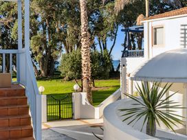 A view of stairs and a garden with trees at Sea Breeze - Orewa Oceanside Apartments Orewa