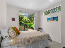 A bedroom with a bed and window at Mangawhai Heads