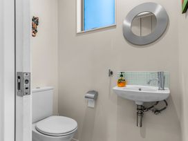 A bathroom with toilet and sink at Mangawhai Heads