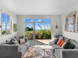 A living room with couches and a coffee table at Mangawhai Heads