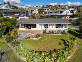 A house with a garden and deck at Cable Bay Retreat Cable Bay