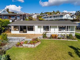 A house with a deck and garden at Cable Bay Retreat in Cable Bay