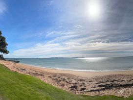 A beach scene with sand and sea at Doubtless Bay Vista - Cable Bay Retreat, Cable Bay