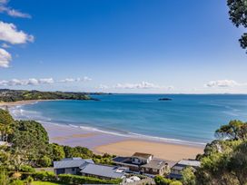 A beach with ocean and houses visible at Paua Shell - Coopers Beach Holiday Home Coopers Beach