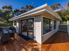 A patio area with a table and chairs at Paua Shell - Coopers Beach Holiday Home Coopers Beach