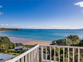 A view of the ocean and beach from a balcony at Paua Shell - Coopers Beach Holiday Home Coopers Beach