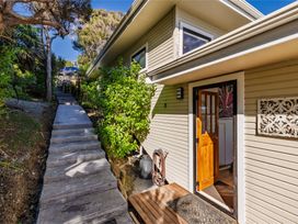 An outdoor entrance with steps leading to a house at Paua Shell - Coopers Beach Holiday Home in Coopers Beach