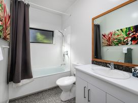 A bathroom with a bathtub and shower at Paua Shell - Coopers Beach