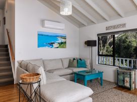 A living room with a sofa and coffee table at Paua Shell - Coopers Beach Holiday Home in Coopers Beach