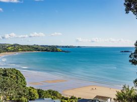 A beach view with ocean and trees at Paua Shell - Coopers Beach Holiday Home, Coopers Beach