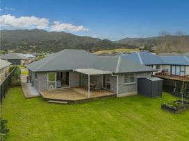 An outdoor view of a house with a deck at Coromandel Holiday Home in Coromandel