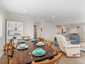 A dining room with a table set for meal at Coromandel Holiday Home Coromandel