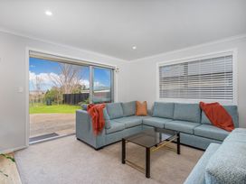 A living room with a sofa and coffee table at Coromandel Holiday Home in Coromandel
