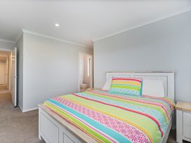 A bedroom with a bed and doorway at Coromandel Holiday Home in Coromandel