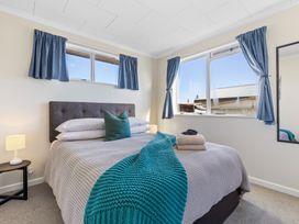 A bedroom with a bed and windows at All Year Round Adventure Base - National Park