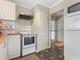 A kitchen with an oven and fridge at All Year Round Adventure Base - National Park