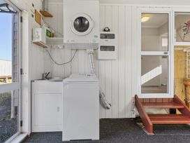 A laundry room with a washing machine and dryer at All Year Round Adventure Base - National Park
