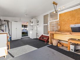A laundry room with a washing machine and storage cabinet at All Year Round Adventure Base - National Park