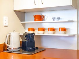 A kitchen with a kettle and coffee machine at All Year Round Adventure Base - National Park