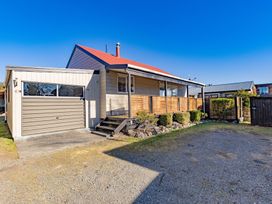 A house with a garage and garden at All Year Round Adventure Base - National Park