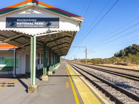 A train station platform with signage at Waimarino National Park in National Park