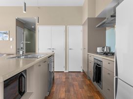 A kitchen with appliances and cabinets at Mangawhai Heads Holiday Home in Mangawhai