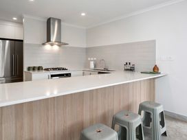 A kitchen with a countertop and bar stools at Repora Holiday Home in Repora