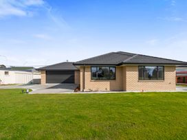A house with a garage and driveway at Reporoa Holiday Home in Reporoa