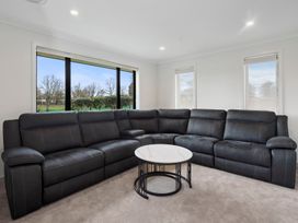 A living room with a sectional sofa and coffee table at Reporea Holiday Home in Reporea