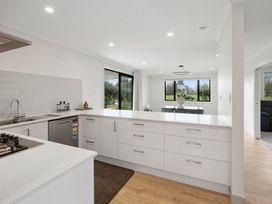 A kitchen with a sink and stove at Reporoa Holiday Home in Reporoa
