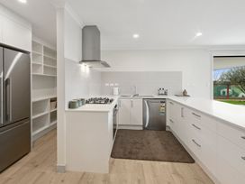 A kitchen with a sink and gas stove at Repora Holiday Home in Repora