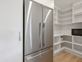 A kitchen with a refrigerator and shelves at Repothoa Holiday Home in Repothoa
