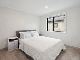 A bedroom with a bed and window at Repora Holiday Home in Reporoa