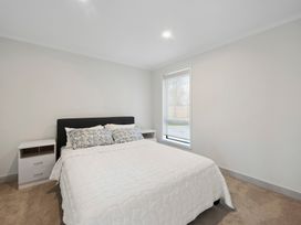 A bedroom with a bed and nightstand at Reporoa Holiday Home in Reporoa