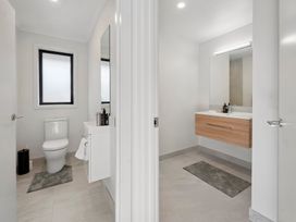 A bathroom with a toilet and wash basin at Reporoa Holiday Home in Reporoa