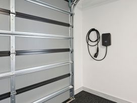 A garage with a garage door and a charging station at Repora Holiday Home in Repora