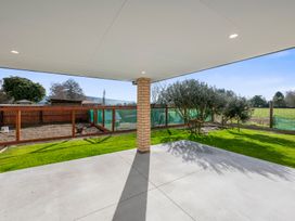 An outdoor area with a patio and grass at Reporoa Holiday Home, Reporoa