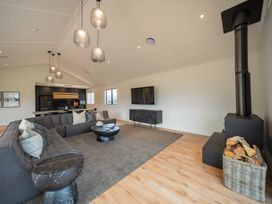 A living room with a sofa and coffee table at Te anau Holiday home in Te Anau