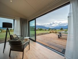A living room with chairs and a table at Te anau Holiday home in Te Anau