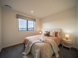 A bedroom with a bed and window at Te anau Holiday home in Te Anau