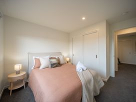 A bedroom with a bed and bedside lamp at Te anau Holiday home in Te Anau