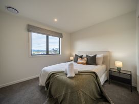 A bedroom with a bed and window at Te anau Holiday home in Te Anau