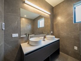 A bathroom with dual sinks and a mirror at Te anau Holiday home in Te Anau