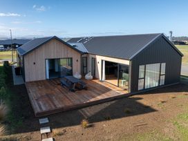 A house with a deck and outdoor seating at Southern Solace - Te Anau Holiday Home, Te Anau
