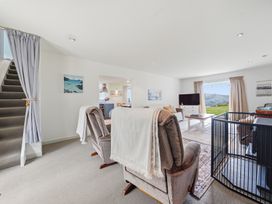 A living room with sofa and armchairs at Akaroa Holiday Home