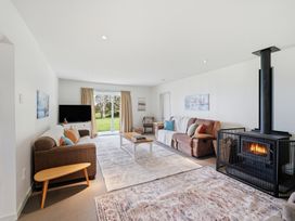 A living room with a television and fireplace at Akaroa Holiday Home