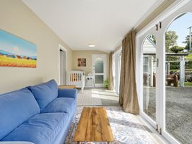A snug area with a sofa and coffee table at Akaroa Holiday Home