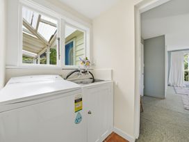 A laundry room with a washing machine and sink at Akaroa Holiday Home 